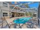 Relax by the private pool with brick patio and covered enclosure connected to the home's second story at 405 Apache Trl, Brandon, FL 33511