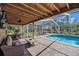 Relaxing screened-in pool area with comfortable seating and a covered patio, perfect for outdoor entertainment at 405 Apache Trl, Brandon, FL 33511