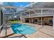 Enjoy this covered in-ground pool with a lounge area, perfect for relaxing and entertaining at 405 Apache Trl, Brandon, FL 33511
