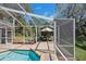 Covered pool area with poolside seating, providing a private outdoor space for leisure and dining at 405 Apache Trl, Brandon, FL 33511