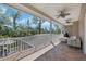 Covered porch with an outdoor seating area and views of mature trees, a screened-in pool, and a lush landscape at 405 Apache Trl, Brandon, FL 33511