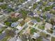 An aerial view reveals a neighborhood with tree lined streets near a commercial area at 4630 W Bay Villa Ave, Tampa, FL 33611