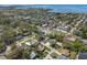 An aerial view of a community with many houses, businesses, and a waterway in the distance at 4630 W Bay Villa Ave, Tampa, FL 33611