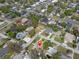An aerial view highlights the property's location in a residential neighborhood near a commercial area at 4630 W Bay Villa Ave, Tampa, FL 33611