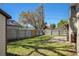 A view of the backyard with a shed, lawn, patio, and fence, offering a private outdoor retreat at 4630 W Bay Villa Ave, Tampa, FL 33611