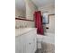 Bathroom with gray tile, a white vanity, and red shower curtain at 4630 W Bay Villa Ave, Tampa, FL 33611