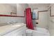 Bathroom with gray tile, a white vanity, and red shower curtain at 4630 W Bay Villa Ave, Tampa, FL 33611