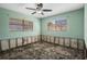 The bedroom features two windows allowing natural light to brighten the room at 4630 W Bay Villa Ave, Tampa, FL 33611