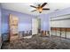 A lavender bedroom with a ceiling fan and a door to a bathroom is in need of renovations at 4630 W Bay Villa Ave, Tampa, FL 33611