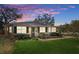 Charming single-story home with a well-manicured lawn and lush landscaping at 4630 W Bay Villa Ave, Tampa, FL 33611