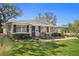 Charming single-story home with a well-manicured lawn and lush landscaping at 4630 W Bay Villa Ave, Tampa, FL 33611