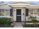 Close-up of a home's front entrance, highlighting the detailed door and garden at 4630 W Bay Villa Ave, Tampa, FL 33611