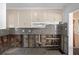 Kitchen featuring upper cabinets, gray backsplash and under-construction features at 4630 W Bay Villa Ave, Tampa, FL 33611