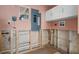 The laundry room offers an electrical panel, cabinets, and a window at 4630 W Bay Villa Ave, Tampa, FL 33611