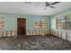 Bright living room offering view to the next room with damage to the walls needing repairs to complete the renovations at 4630 W Bay Villa Ave, Tampa, FL 33611