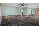 Spacious living room open concept with damage needing repairs for a homeowner to put their custom touch at 4630 W Bay Villa Ave, Tampa, FL 33611
