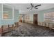 Bright living room offering view to the next room with damage to the walls needing repairs to complete the renovations at 4630 W Bay Villa Ave, Tampa, FL 33611
