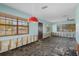 Bright and open living area offers renovation potential, featuring large windows and a ceiling fan at 4630 W Bay Villa Ave, Tampa, FL 33611
