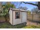 The backyard shed provides additional storage space, complete with a window and a door at 4630 W Bay Villa Ave, Tampa, FL 33611