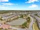 Community aerial view showcasing a central lake, lush landscaping, walking trails, and thoughtfully designed homes at 5086 San Martino Dr, Wesley Chapel, FL 33543