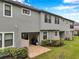 Home's backyard with a covered patio and neatly trimmed landscaping at 5086 San Martino Dr, Wesley Chapel, FL 33543
