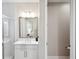 Bright bathroom with glass shower, vanity and a large mirror at 5086 San Martino Dr, Wesley Chapel, FL 33543