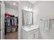 Bathroom featuring a vanity with white cabinets and a walk-in closet at 5086 San Martino Dr, Wesley Chapel, FL 33543