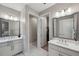 Bathroom with dual sinks, modern fixtures and neutral paint at 5086 San Martino Dr, Wesley Chapel, FL 33543