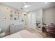 Bright bedroom with colorful posters, large dresser, and adjacent bath at 5086 San Martino Dr, Wesley Chapel, FL 33543