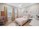 Cozy bedroom featuring large windows, a ceiling fan, a bed, and decor at 5086 San Martino Dr, Wesley Chapel, FL 33543