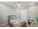 Neutral bedroom featuring a full-size bed, desk, and closet at 5086 San Martino Dr, Wesley Chapel, FL 33543