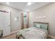 Bedroom with decor, a full-size bed, and a window for natural light at 5086 San Martino Dr, Wesley Chapel, FL 33543
