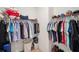 Walk-in closet with double hanging racks and shelving at 5086 San Martino Dr, Wesley Chapel, FL 33543