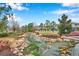 Scenic creek featuring rock landscaping, a wooden bridge, and beautiful, lush green foliage at 5086 San Martino Dr, Wesley Chapel, FL 33543