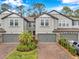 Charming townhomes with gray exteriors, brick driveways, and well-maintained landscaping, creating a welcoming curb appeal at 5086 San Martino Dr, Wesley Chapel, FL 33543