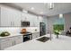 This bright kitchen has white cabinets, stainless appliances, marble countertops and a deep stainless sink at 5086 San Martino Dr, Wesley Chapel, FL 33543