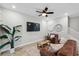 Comfortable living room features stairs, hardwood floors and a large plant at 5086 San Martino Dr, Wesley Chapel, FL 33543