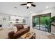 Open living space with modern kitchen, comfortable couch, and access to backyard at 5086 San Martino Dr, Wesley Chapel, FL 33543