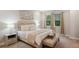 Bright bedroom with a king bed, a tray ceiling, an art piece and large windows at 5086 San Martino Dr, Wesley Chapel, FL 33543