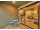 Relaxing patio featuring a view of the living room through a glass sliding door at 5086 San Martino Dr, Wesley Chapel, FL 33543