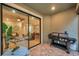 Covered patio with a brick floor, a grill, and a view into the house through large sliding glass doors at 5086 San Martino Dr, Wesley Chapel, FL 33543