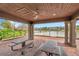 Lakeside brick pavilion with picnic tables, ceiling fan, and stunning water views at 5086 San Martino Dr, Wesley Chapel, FL 33543