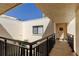 Exterior building shot showcasing walkway, and front door with accent wreath under a sunny sky at 5729 Puerta Del Sol Boulevard South # 486, St Petersburg, FL 33715