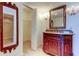 Bathroom featuring a vanity with granite counter, ornate mirror, and sconce lighting at 5729 Puerta Del Sol Boulevard South # 486, St Petersburg, FL 33715
