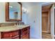 Bathroom featuring a vanity with granite counter, ornate mirror, sconce lighting, and shower at 5729 Puerta Del Sol Boulevard South # 486, St Petersburg, FL 33715