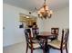 View into kitchen from dining room with chandelier and table with chairs at 5729 Puerta Del Sol Boulevard South # 486, St Petersburg, FL 33715