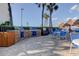 Outdoor grilling area with built-in grills, seating, and views of palm trees at 5729 Puerta Del Sol Boulevard South # 486, St Petersburg, FL 33715
