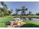 Outdoor seating with picnic table, benches, and a view of the community pond at 5729 Puerta Del Sol Boulevard South # 486, St Petersburg, FL 33715