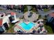 Aerial view of a community pool area with lounge chairs, tables, and tiki umbrellas at 5729 Puerta Del Sol Boulevard South # 486, St Petersburg, FL 33715