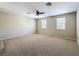 Spacious bedroom featuring a ceiling fan and two bright windows at 5818 Butterfield St, Riverview, FL 33578